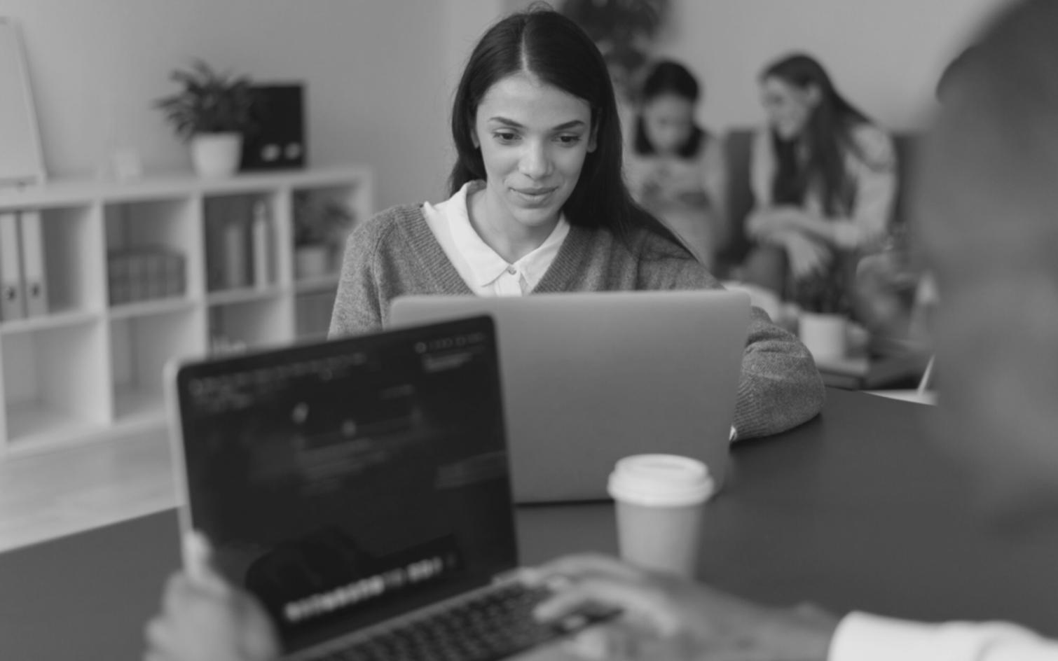 Financial analyst reviewing market data and investment reports at modern workstation